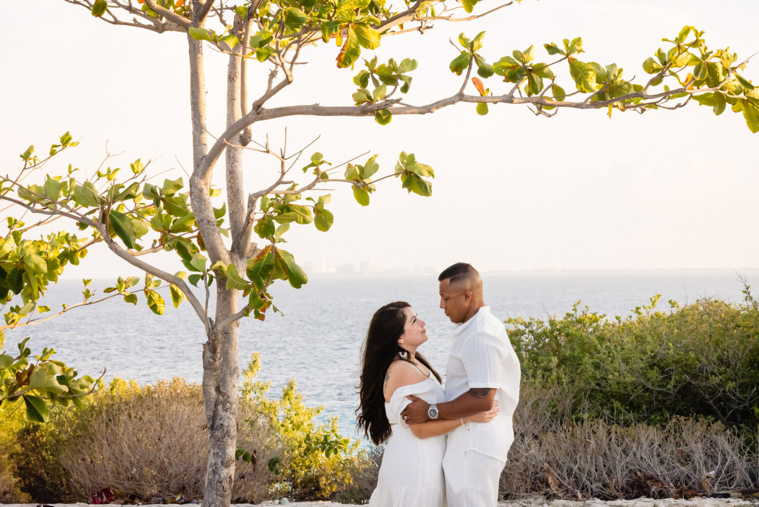 Honeymoon photography in Isla Mujeres – couple walking along the beach at sunset.