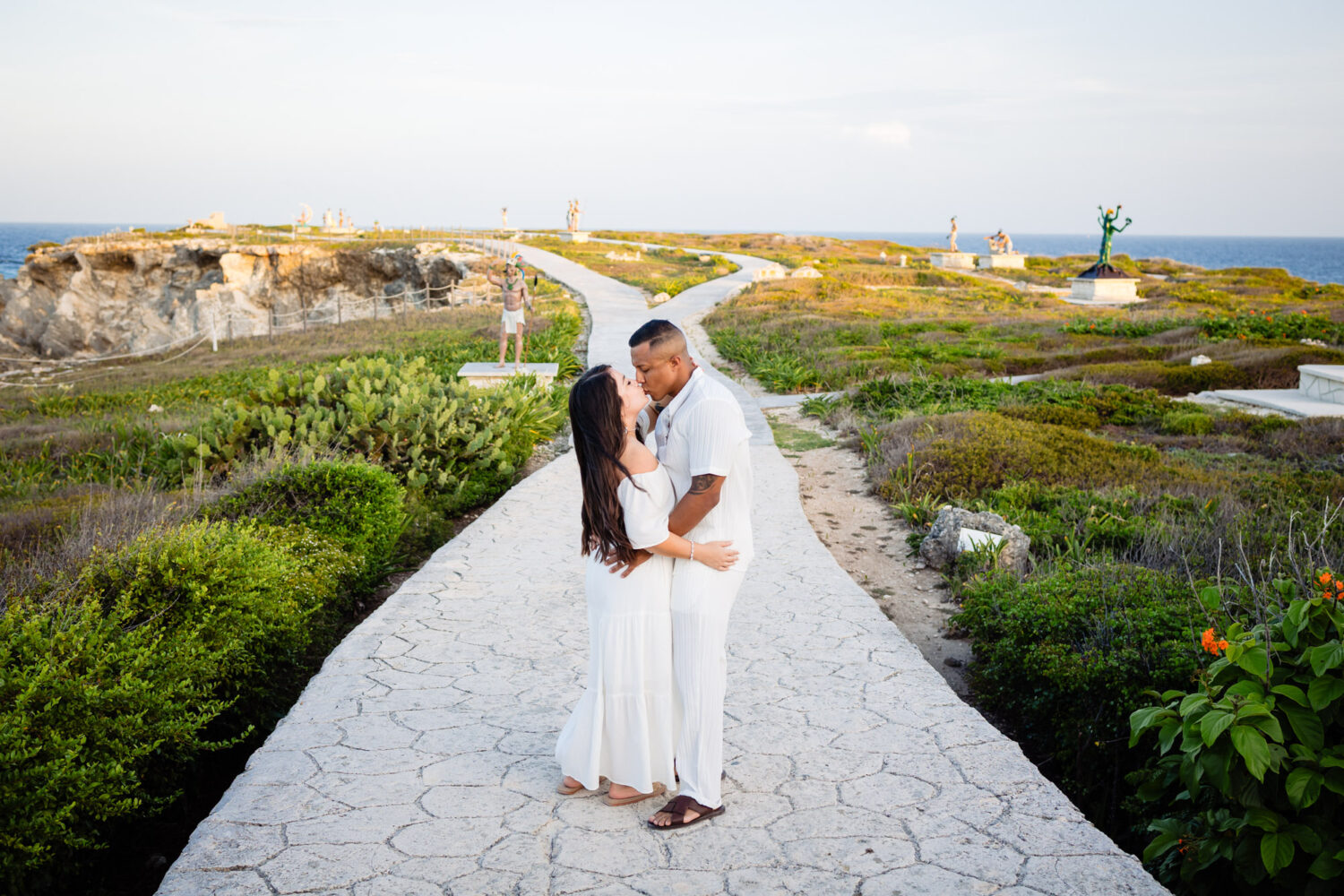 Honeymoon photography in Isla Mujeres – couple walking along the beach at sunset.