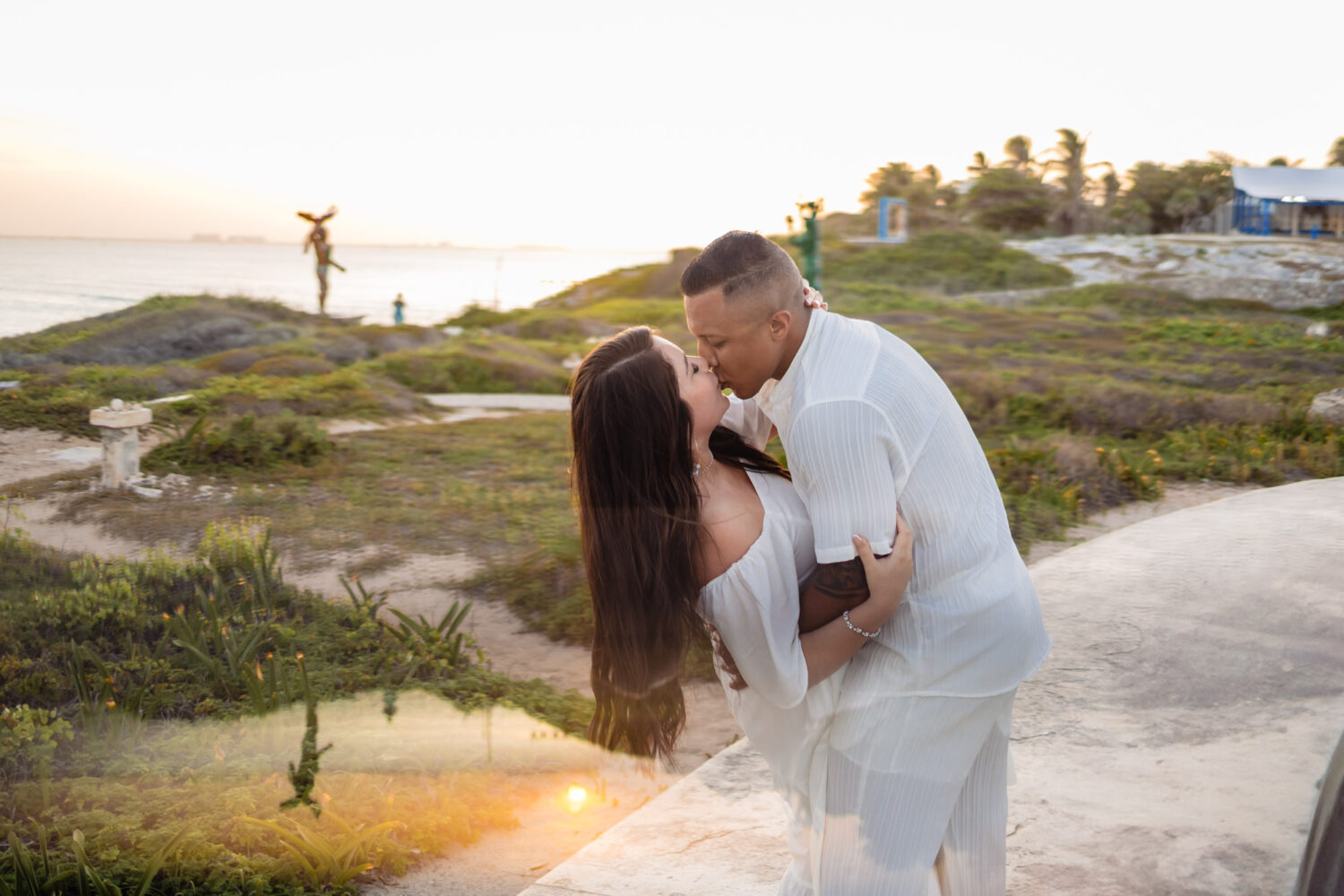 Honeymoon photography in Isla Mujeres – couple walking along the beach at sunset.