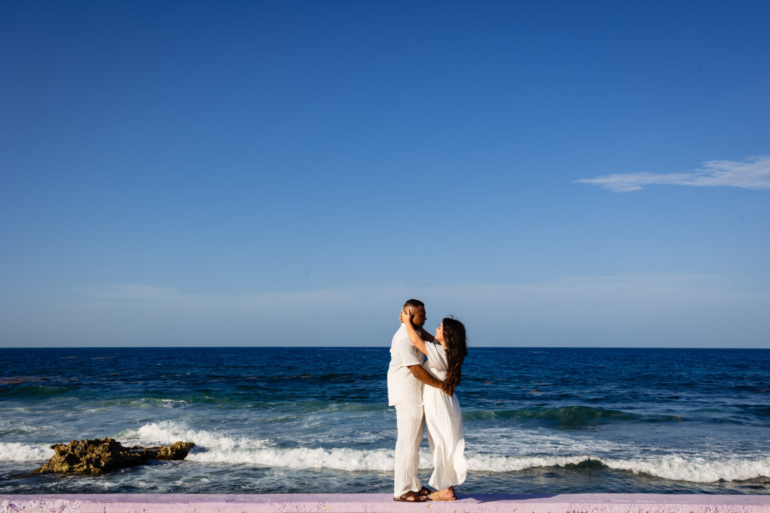 Couple celebrating honeymoon in Isla Mujeres with Caribbean turquoise waters.