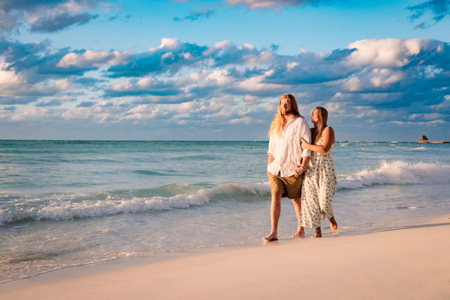 couple walking at Playa Norte Isla Mujeres sunset photoshoot